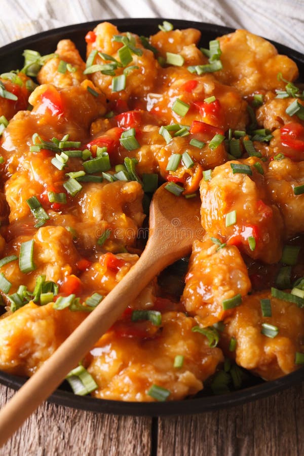 Spicy chicken in orange sauce closeup. vertical stock photo Spicy chicken in orange sauce closeup. vertical stock photo