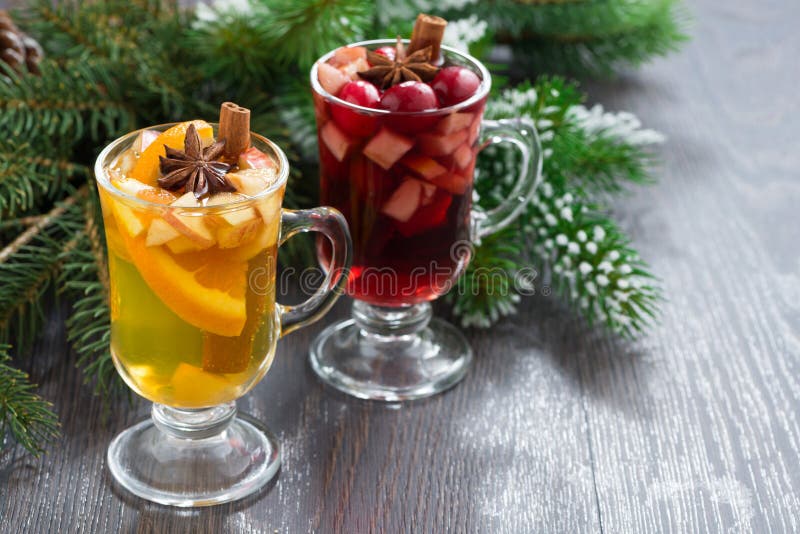 Spicy Christmas drinks in glasses on a wooden background