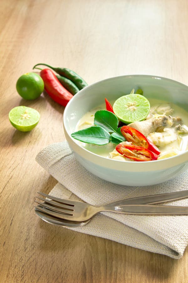 Spicy creamy coconut soup with chicken , Thai food called Tom Kha Gai on the wooden table stock photography Spicy creamy coconut soup with chicken , Thai food called Tom Kha Gai on the wooden table stock photography