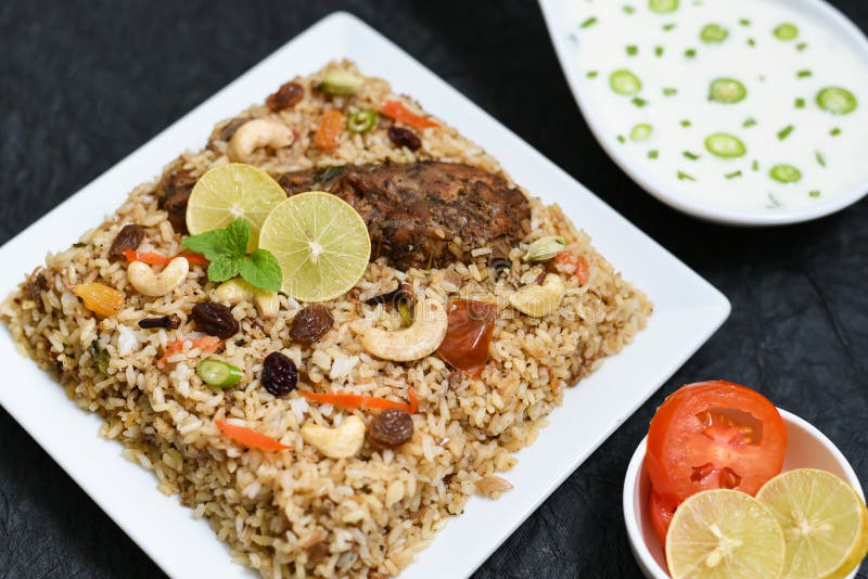 Spicy and delicious chicken biryani in traditional clay pot. Malabar biryani or Hydrabadi chicken biryani, Dum Biriyani, Chicken pulao basmati rice, herbs, raitha for Ramadan Kareem, Eid-Ul-Adha. Chicken dum biryani stock images, royalty-free photos and pictures