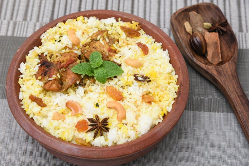 Spicy and delicious chicken biryani in traditional clay pot. Malabar biryani or Hydrabadi chicken biryani, Dum Biriyani, Chicken pulao basmati rice, herbs, raitha for Ramadan Kareem, Eid-Ul-Adha. Chicken dum biryani stock images, royalty-free photos and pictures