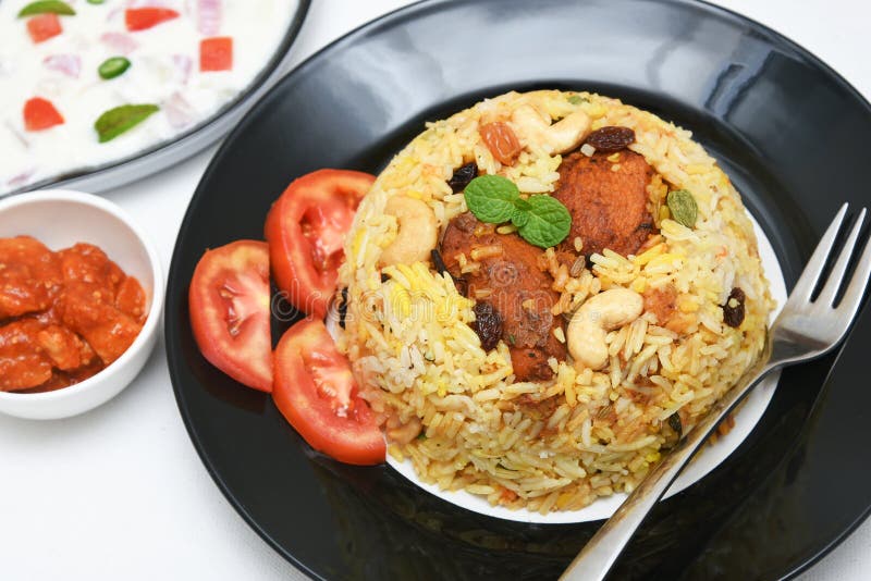Spicy and delicious chicken biryani in traditional clay pot. Malabar biryani or Hydrabadi chicken biryani, Dum Biriyani, Chicken pulao basmati rice, herbs, raitha for Ramadan Kareem, Eid-Ul-Adha. Chicken dum biryani stock images, royalty-free photos and pictures