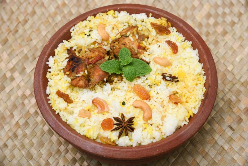 Spicy and delicious chicken biryani in traditional clay pot. Malabar biryani or Hydrabadi chicken biryani, Dum Biriyani, Chicken pulao basmati rice, herbs, raitha for Ramadan Kareem, Eid-Ul-Adha. Chicken dum biryani stock images, royalty-free photos and pictures