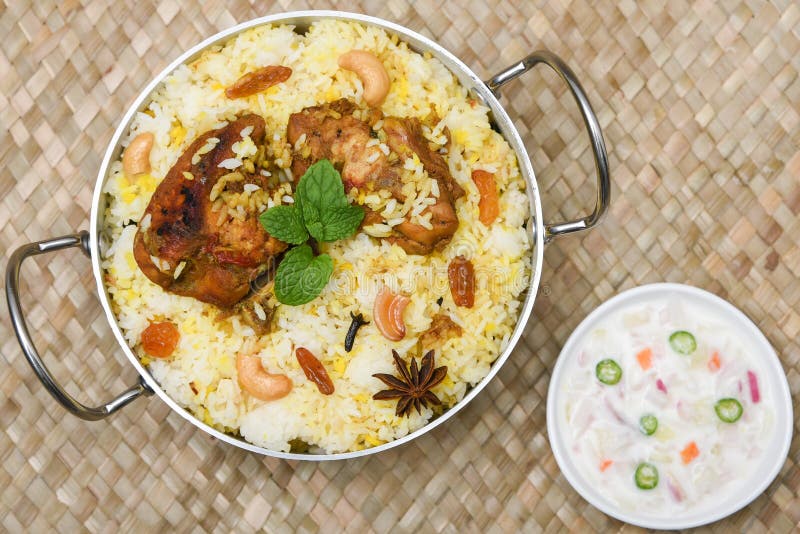 Spicy and delicious chicken biryani in traditional clay pot. Malabar biryani or Hydrabadi chicken biryani, Dum Biriyani, Chicken pulao basmati rice, herbs, raitha for Ramadan Kareem, Eid-Ul-Adha. Chicken dum biryani stock images, royalty-free photos and pictures