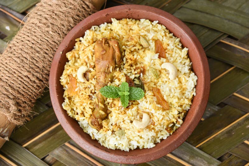 Spicy and delicious chicken biryani in traditional clay pot. Malabar biryani or Hydrabadi chicken biryani, Dum Biriyani, Chicken pulao basmati rice, herbs, raitha for Ramadan Kareem, Eid-Ul-Adha. Chicken dum biryani stock images, royalty-free photos and pictures
