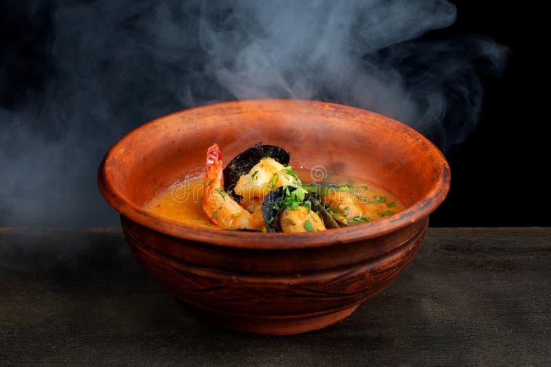 Spicy french soup with seafood in a clay plate. stock photos Spicy french soup with seafood in a clay plate. stock photos