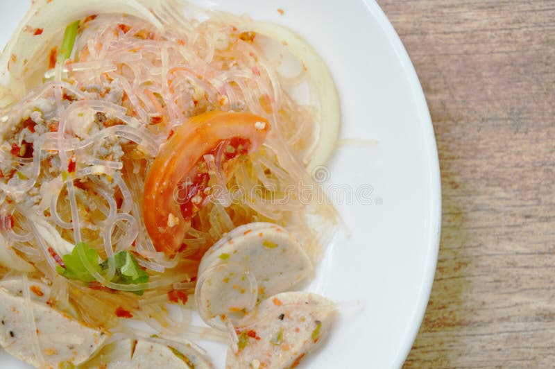 Spicy glass noodles with slice Vietnamese sausage and onion Thai salad on plate royalty free stock images Spicy glass noodles with slice Vietnamese sausage and onion Thai salad on plate royalty free stock images