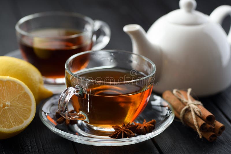 Spicy hot black tea in glass cup with lemon, cinnamon and star a