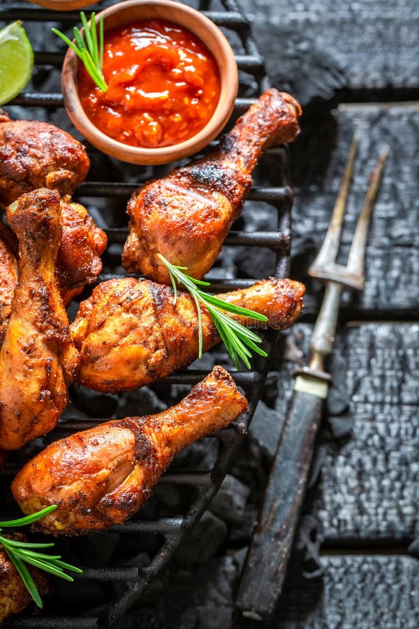Spicy and hot grilled chicken leg with sauces and lime royalty free stock photo Spicy and hot grilled chicken leg with sauces and lime royalty free stock photo