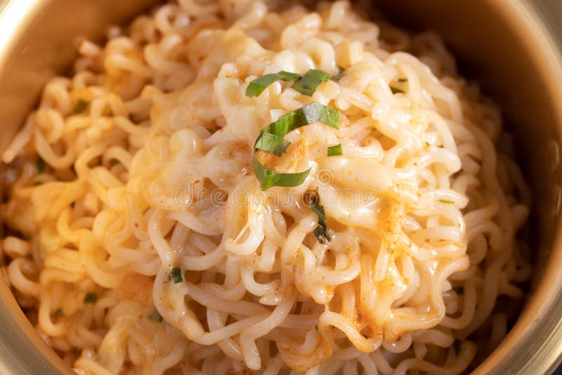 Spicy Instant Noodle in a Golden Pot with Mozzarella Cheese Stock Image