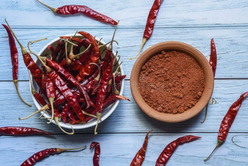 Spicy Red Chilli Powder with Super Chilli Background Stock Photo