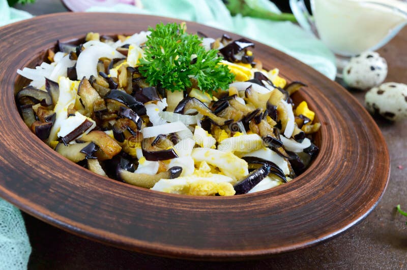 Spicy Salad of Fried Eggplant, Boiled Egg, Marinated Onions in a Bowl