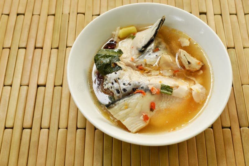 Spicy Salmon Fish Head and Straw Mushroom in Tom Yum Soup on Bowl Stock ...