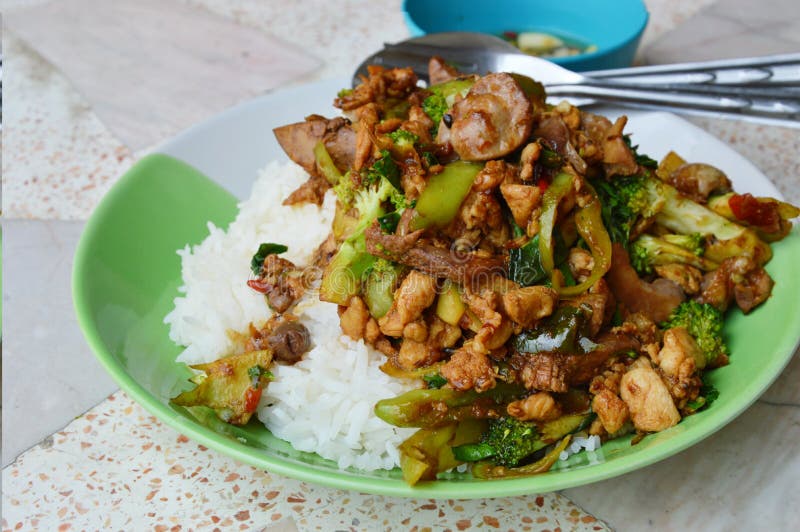 Spicy Stir-fried Chicken Innards with Basil Leaves on Rice Stock Image ...