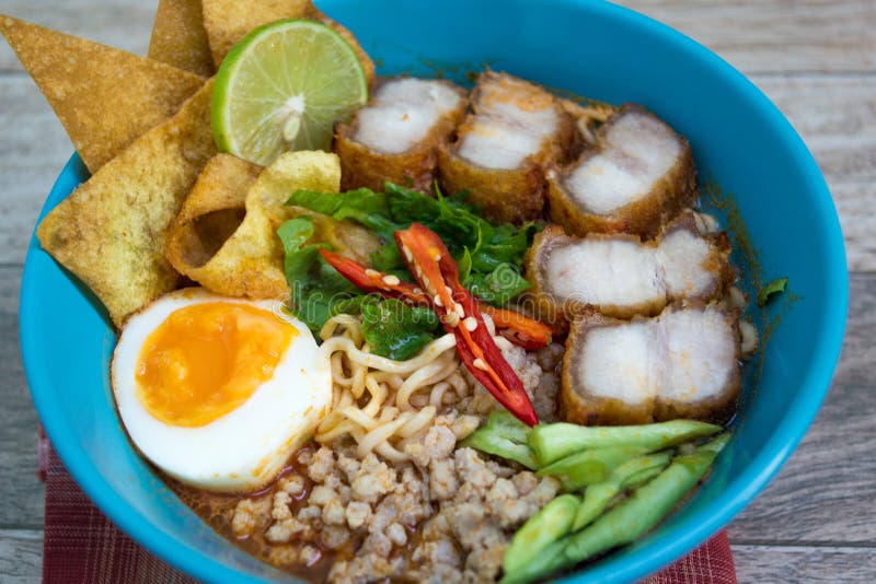 Spicy tomyum noodle on wood background