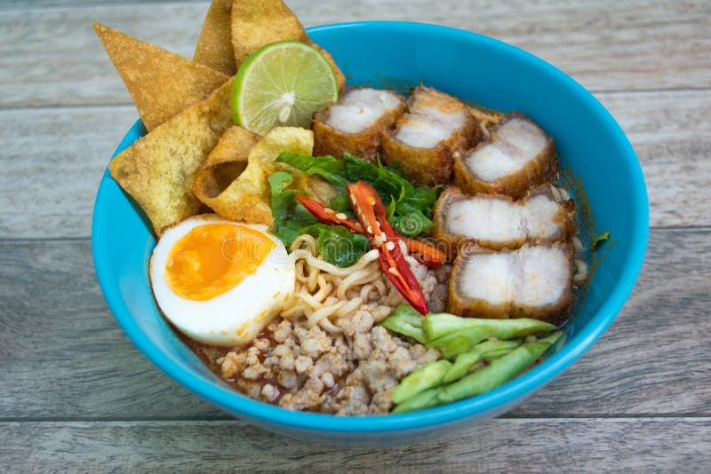 Spicy tomyum noodle on wood background