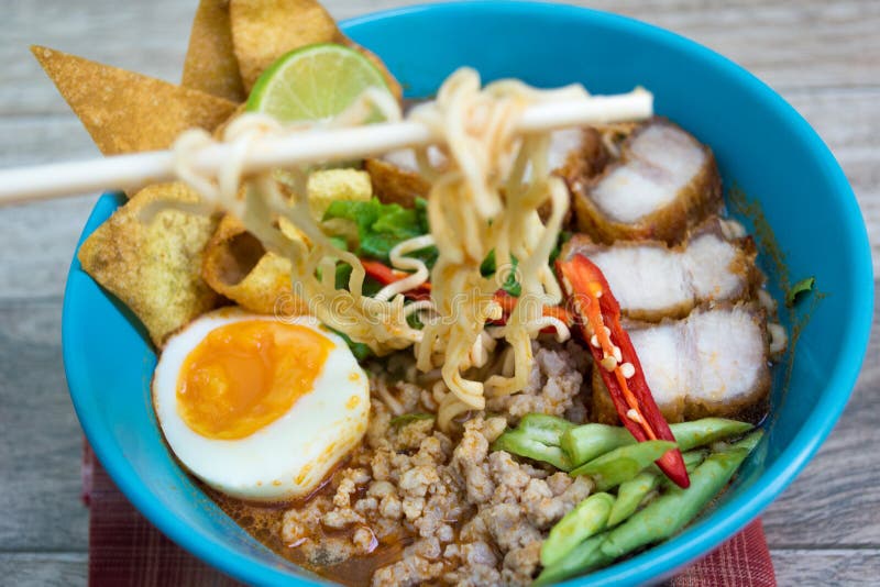 Spicy tomyum noodle on wood background