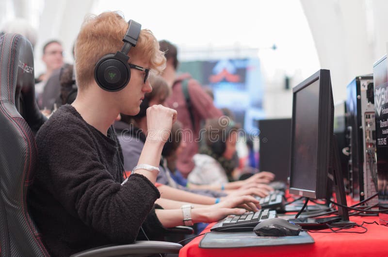 Spielspiel des jungen Mannes auf Personal-Computer bei Animefest lizenzfreies stockbild Spielspiel des jungen Mannes auf Personal-Computer bei Animefest lizenzfreies stockbild