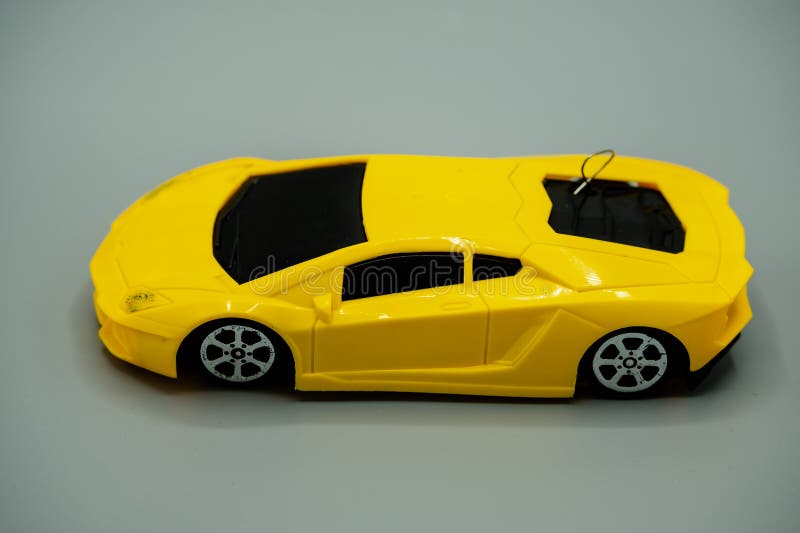 luxury yellow battery operated car. for children yellow die-cat toy modern car with antenna isolated on gray background, metal car with modern design, battery operated. luxury yellow battery operated car. for children yellow die-cat toy modern car with antenna isolated on gray background, metal car with modern design, battery operated.