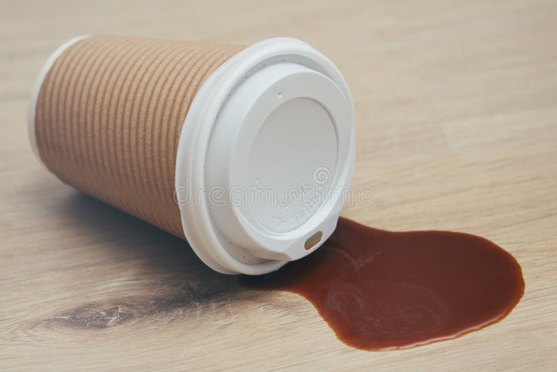 Spilled liquid on the floor. Paper coffee cup with plastic lid. Garbage. Sticky surface. Need cleaning. stock photography Spilled liquid on the floor. Paper coffee cup with plastic lid. Garbage. Sticky surface. Need cleaning. stock photography