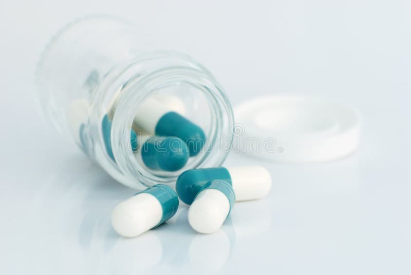 Spilling capsules from a bottle royalty free stock photos