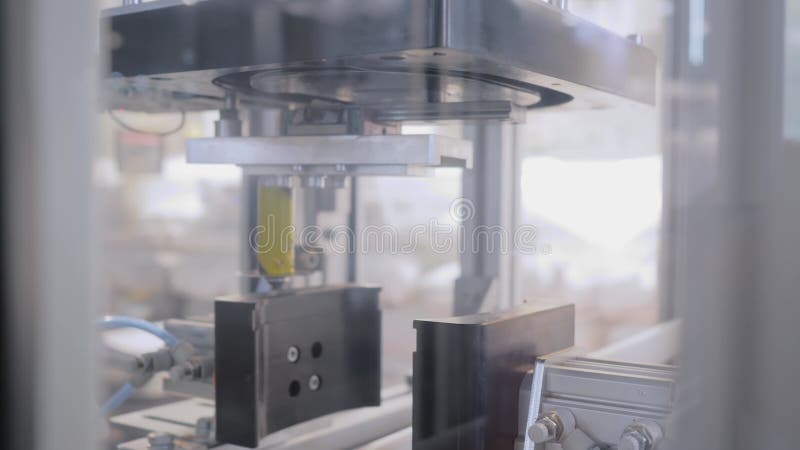 Spin dome trimmer cutting empty orange plastic jerrycans on conveyor belt stock footage
