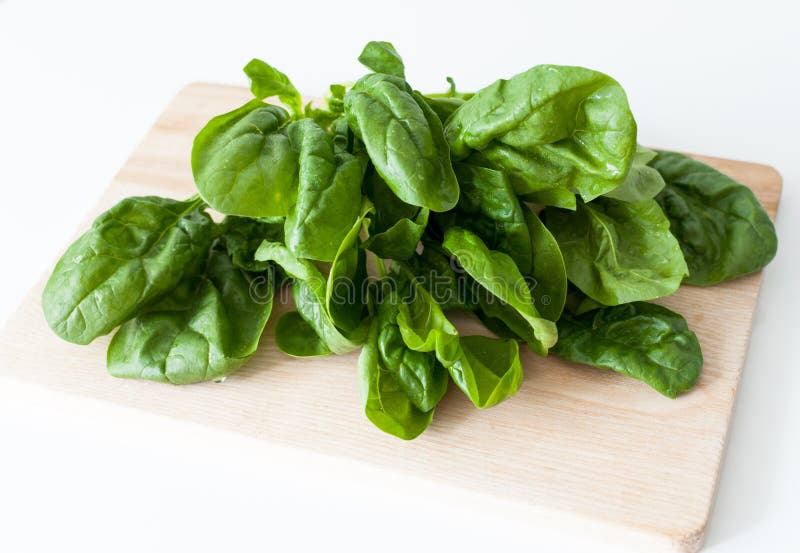 Spinach. Fresh spinach on a wooden cutting board royalty free stock image