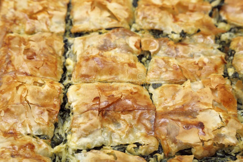 Homemade spinach pie cut in square pieces closeup. Crispy diet stock images, royalty-free photos and pictures