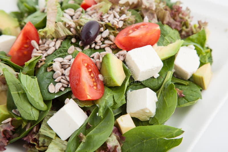 Spinach Salad with Avocado, Feta Cheese, Tomatoes and Seeds Stock Image