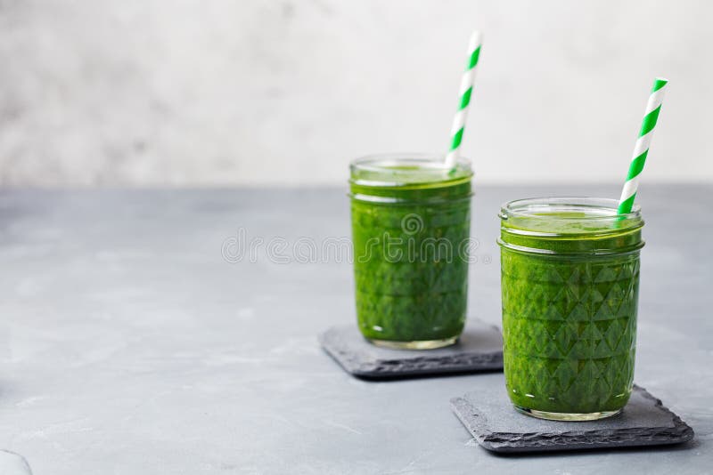 Spinach Smoothie Healthy Drink In Glass Jar On Grey Stone Background. Copy Space Stock Photo