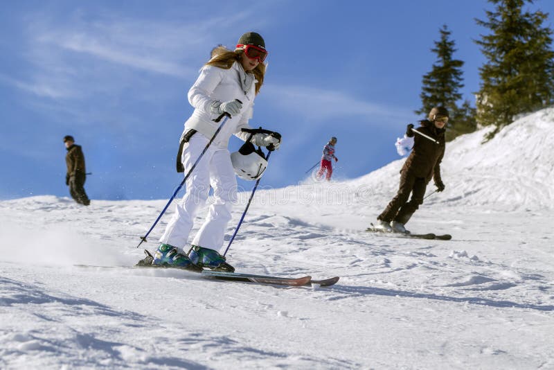 SPINDLERUV MLYN, CZECH REPUBLIC on March 03 2013.Young active woman skiing on the slopes of the mountains on a winter sunny day.