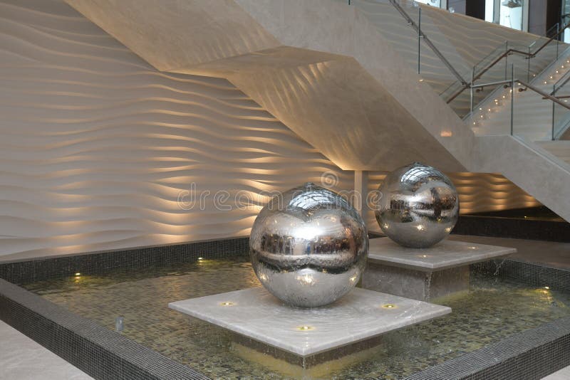 Spinning Reflective Ball Fountain. Water Fountain in the Form of a Ball