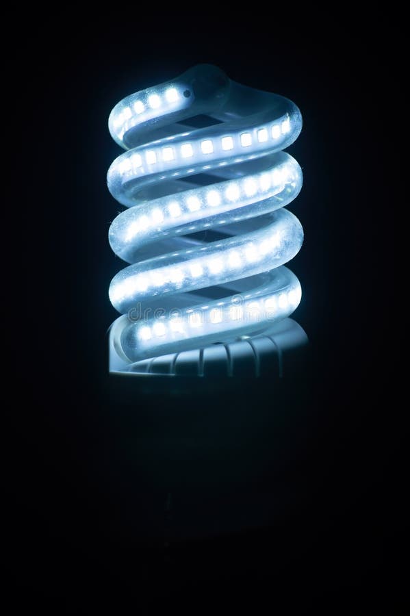 Spiral LED bulb with cool blue light. royalty free stock photo