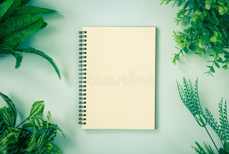 Spiral Notebook or Spring Notebook and Office Plants at Corner on Minimalist Background in Vintage Tone