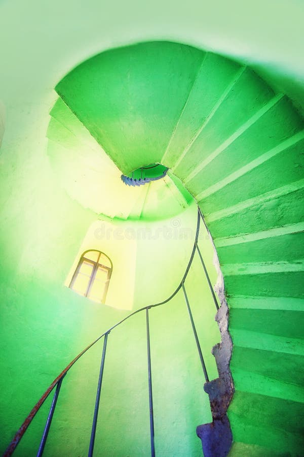 A spiral staircase in the green lighthouse stock photos