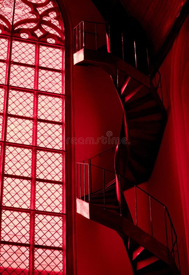 Spiral staircase and window in red church in Amsterdam stock image Spiral staircase and window in red church in Amsterdam stock image