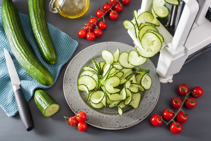 Spiralizing cucumber vegetable with spiralizer stock photos