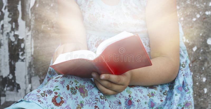 Spiritual education . the prayer book in the child`s hands . Religion background . sacred book. Spiritual education . the prayer book in the child`s hands . Religion background . sacred book