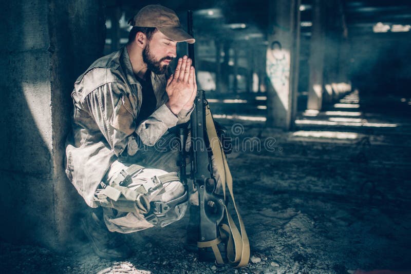 Spiritual man is sitting in squat position and praying. He is keeping his eyes closed and holding hands together close stock images Spiritual man is sitting in squat position and praying. He is keeping his eyes closed and holding hands together close stock images
