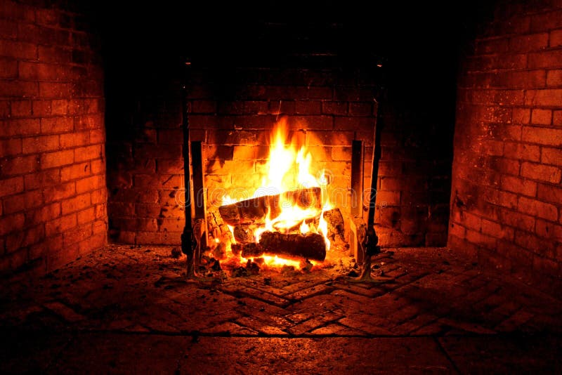 Blazing fireplace with brick surrounding. Blazing fireplace with brick surrounding