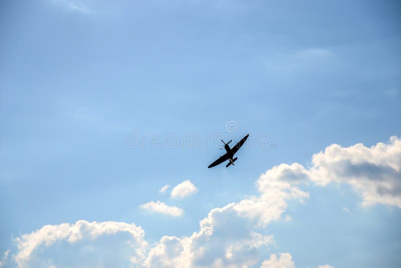 Spitfire on blue cloudy sky