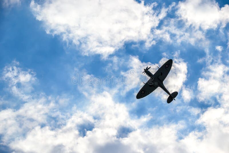 Spitfire on blue cloudy sky