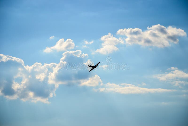 Spitfire in flight on blue cloudy sky