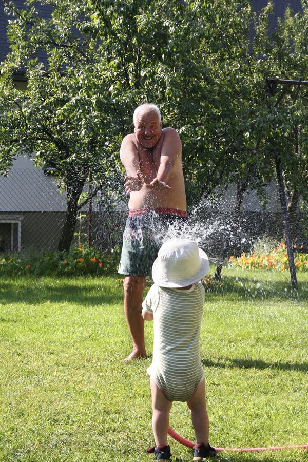 Pouring grandfather boy. Pouring grandfather boy