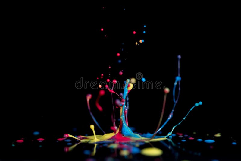 Splash of colorful liquid paint on a black background paint splash on black background