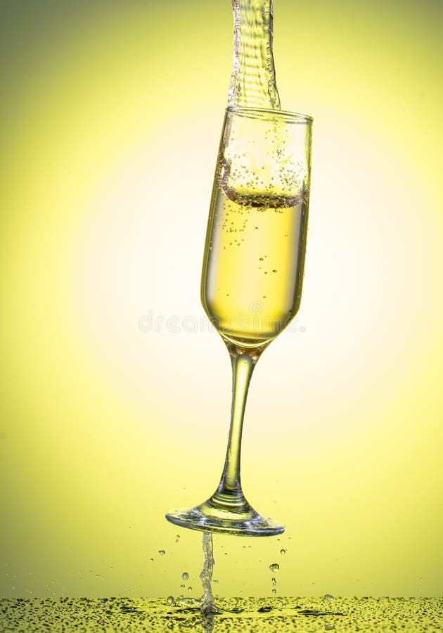 Splash In A Falling Champagne Glass On A Color Yellow Gradient