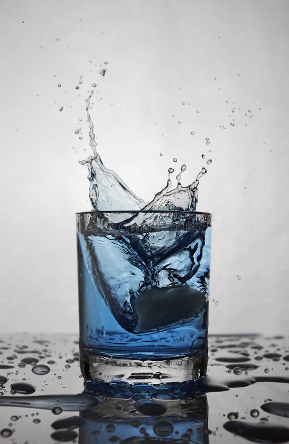 Blue Splash in Glass of White Transparent Alcoholic Cocktail Drink with