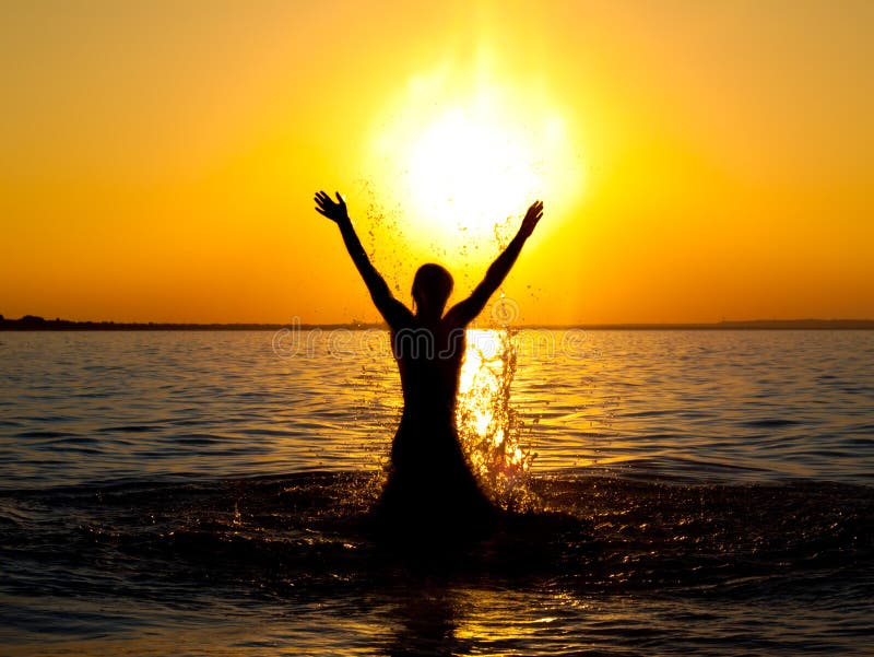 Swimmer jumping out of sea water on golden sunrise. Swimmer jumping out of sea water on golden sunrise