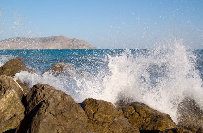 A splash of sea waves on the coast near the stones stock photo A splash of sea waves on the coast near the stones stock photo