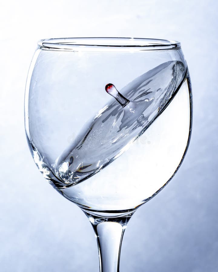 A splash of water in a glass, a falling drop. stock images A splash of water in a glass, a falling drop. stock images